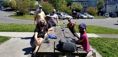 Julie Bassuk, James DuBois, Gretchen Van Bodegom, Erica Bush, and their families enjoy a break in the summer sun at Judkins Park.