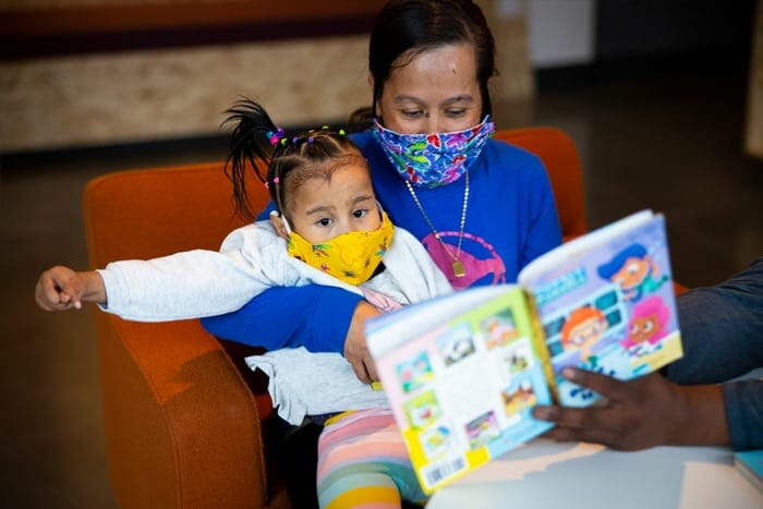 Photo of a mother and child reading