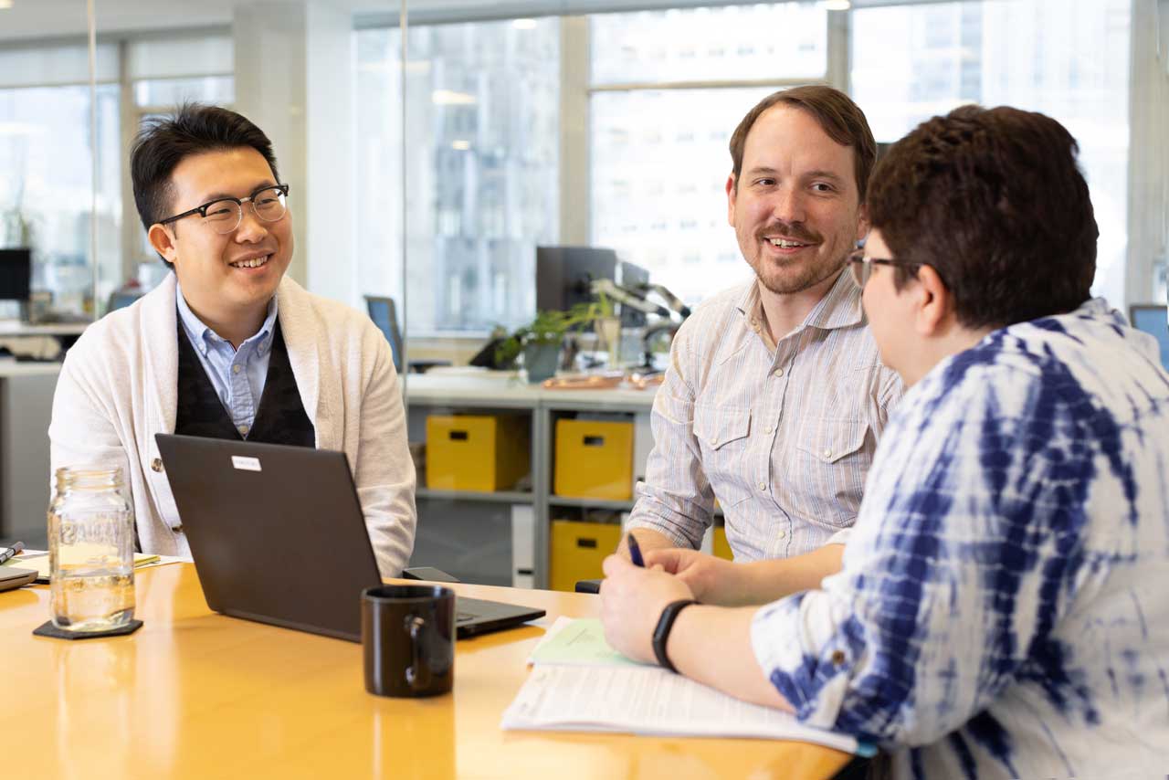 image of a team in a conference room discussing a project